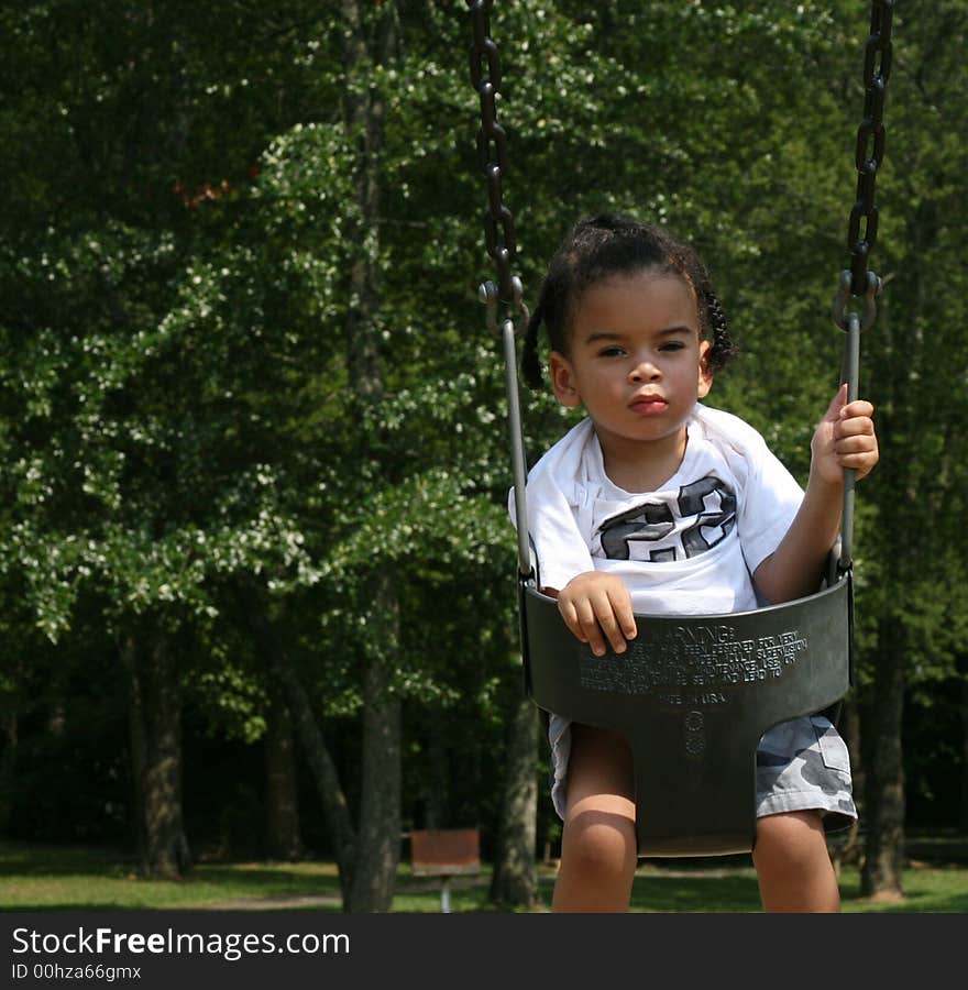 Toddler on the swing at the playground. Toddler on the swing at the playground