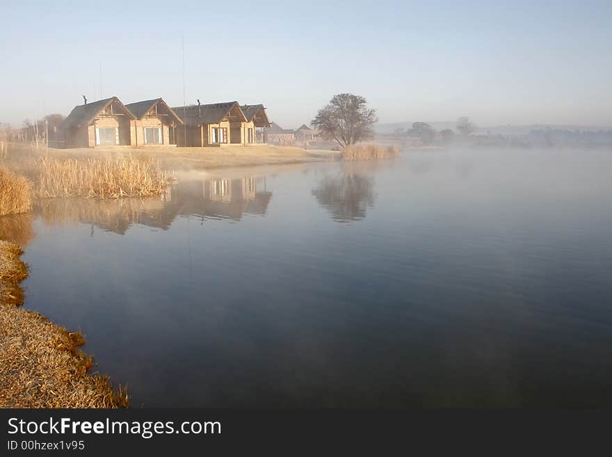 Some chalets overlooking a lake at sunrise. Some chalets overlooking a lake at sunrise