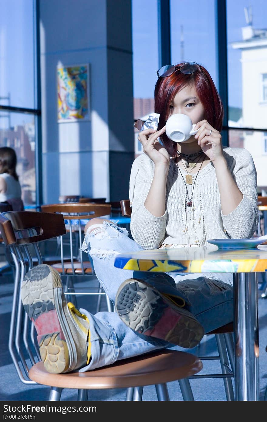 Cafe. Pretty girl having a cup of coffee with a piece of chocolate. Cafe. Pretty girl having a cup of coffee with a piece of chocolate.