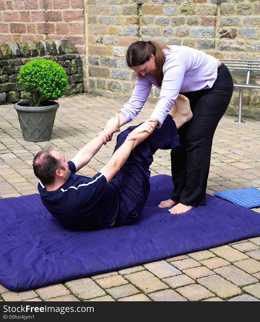 Preparing for shoulder stand as part of a Thai body massage