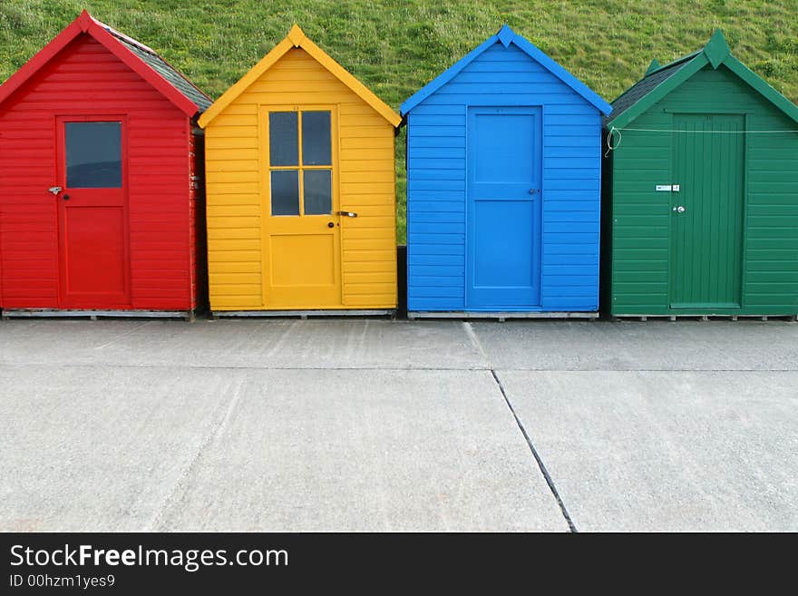 A row of four similar, but different, beach huts. A row of four similar, but different, beach huts