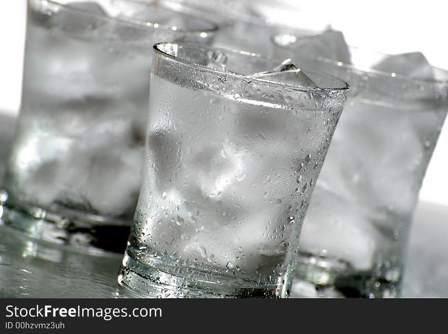 Glass of fresh water with ice close up