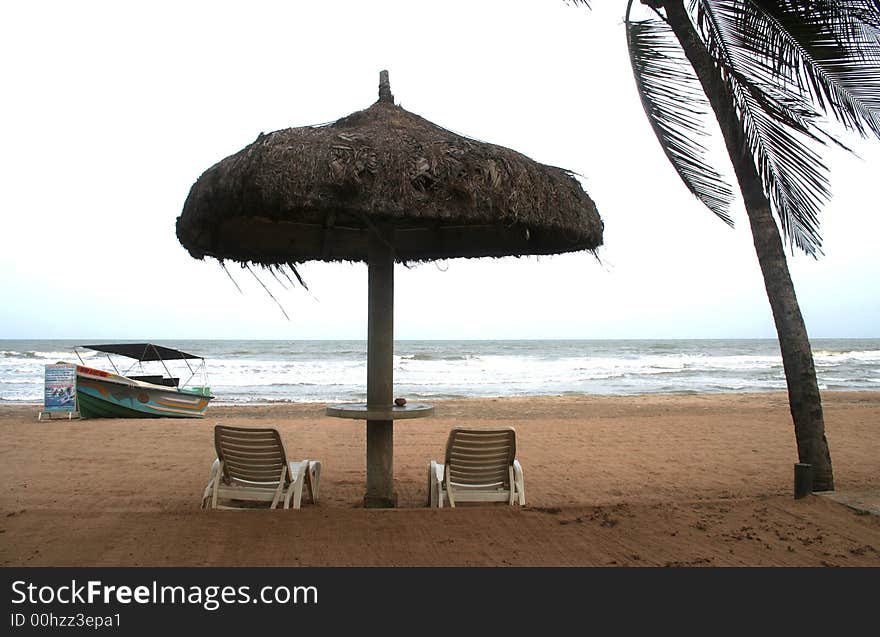 Deckchair on a tropical beach with sky and white sand