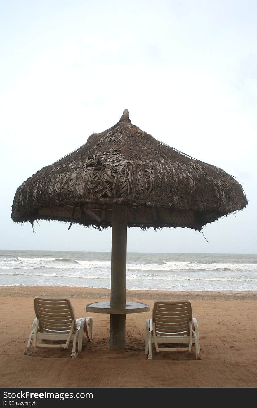 Deckchair on a tropical beach with sky and white sand