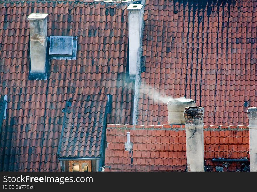 Roofs with red tiling, pipes, a wind. Roofs with red tiling, pipes, a wind