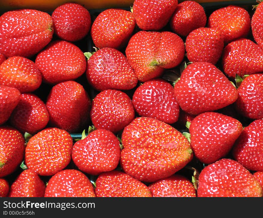 Fresh strawberries at a local market. Fresh strawberries at a local market.