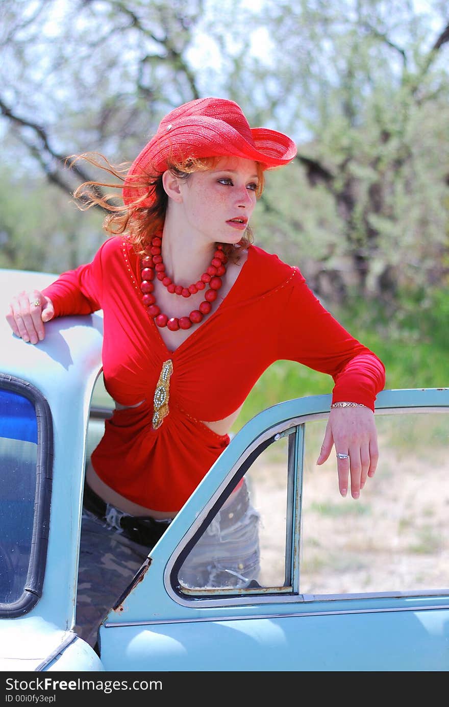 The girlon the red hat and old car. The girlon the red hat and old car