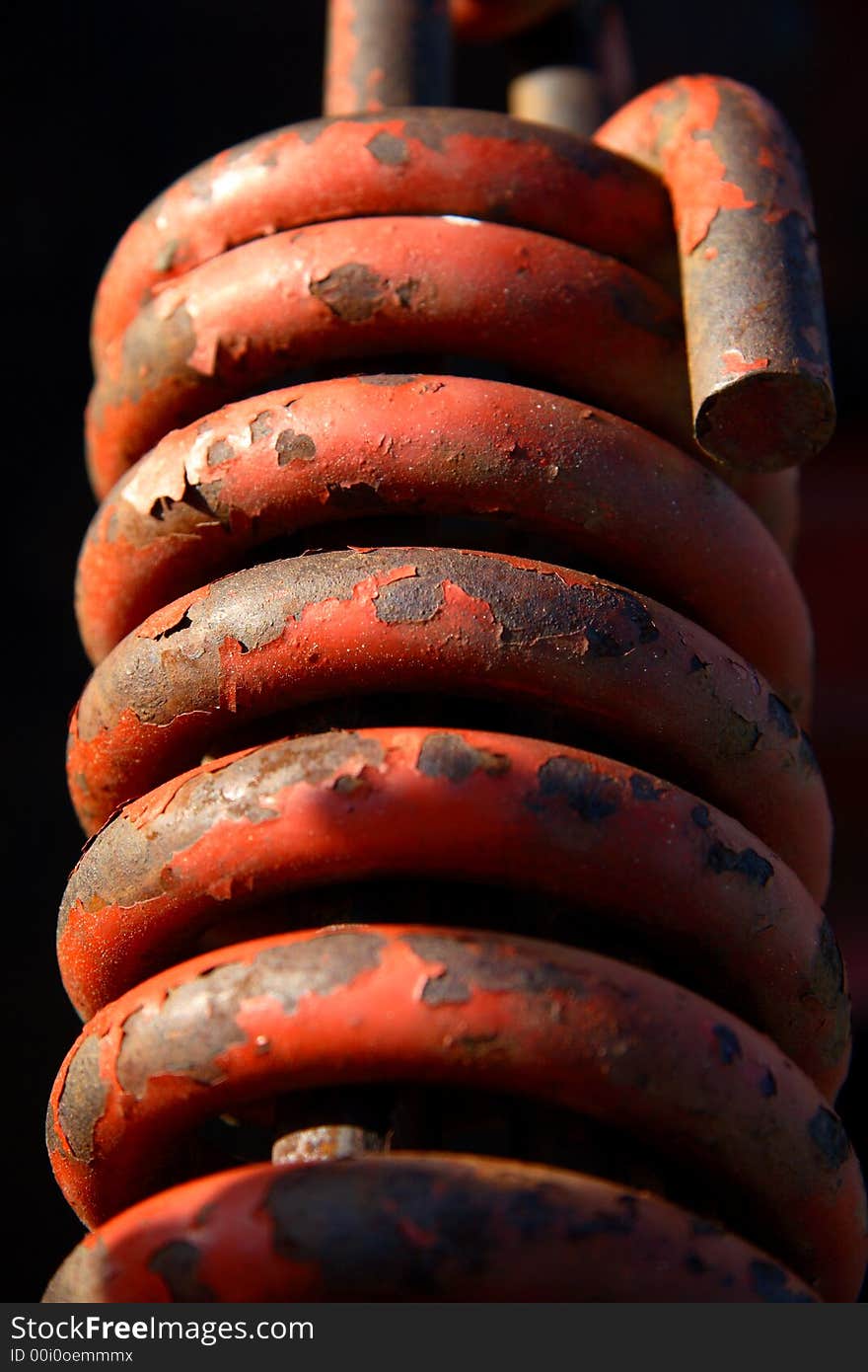 A heavy spring from a piece of heavy equipment machinery.