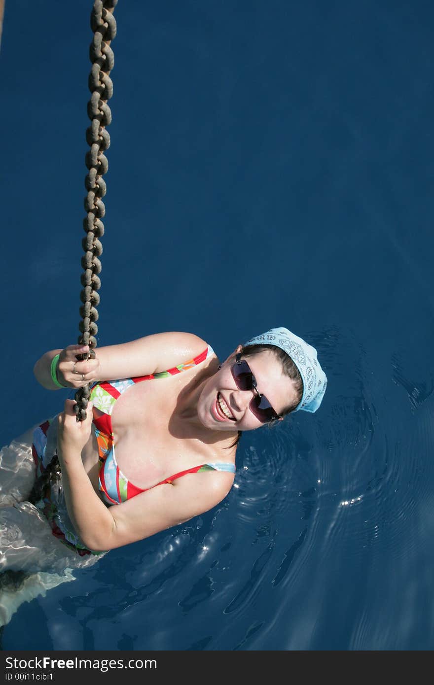 The girl bathing in the sea, has hung on an anchor circuit of a yacht. The girl bathing in the sea, has hung on an anchor circuit of a yacht.