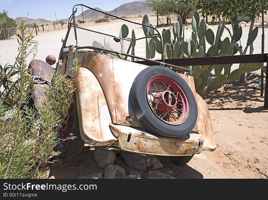 Old metal parts, rusty car on desert