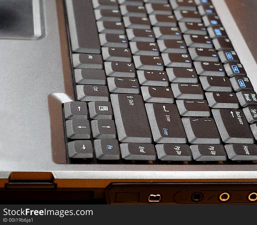 Close-up of silver laptop with black keyboard. Close-up of silver laptop with black keyboard