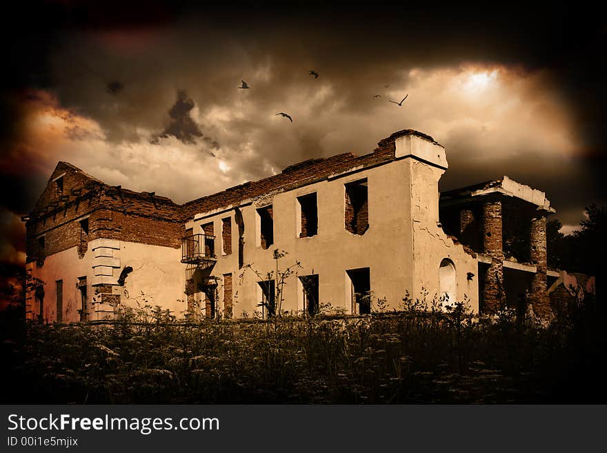 The old destroyed building above which birds fly. The old destroyed building above which birds fly