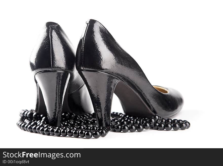 Black patent-leather shoes on the white background