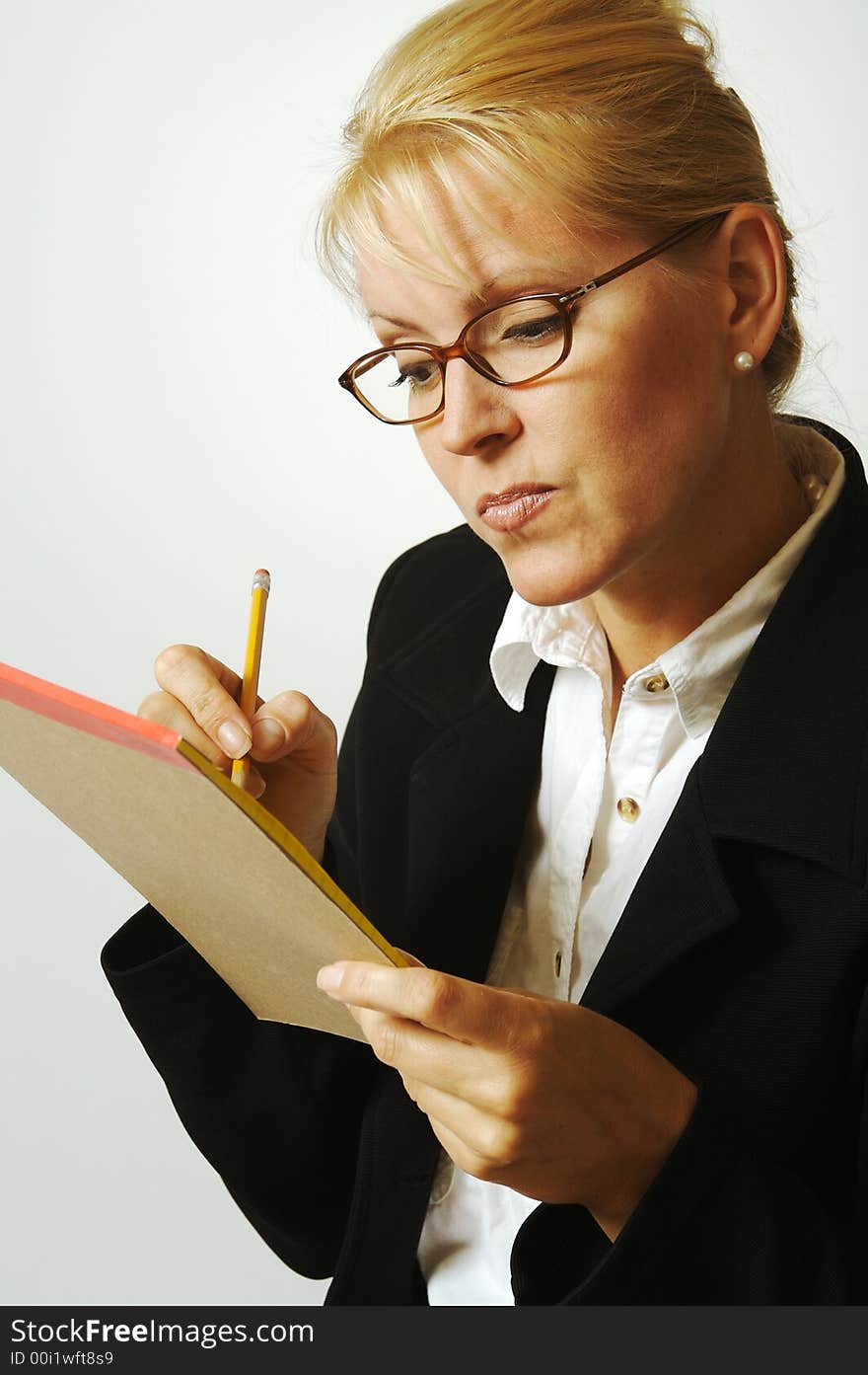 Beautiful Pensive Woman Taking Notes with Pencil & Notepad. Beautiful Pensive Woman Taking Notes with Pencil & Notepad.