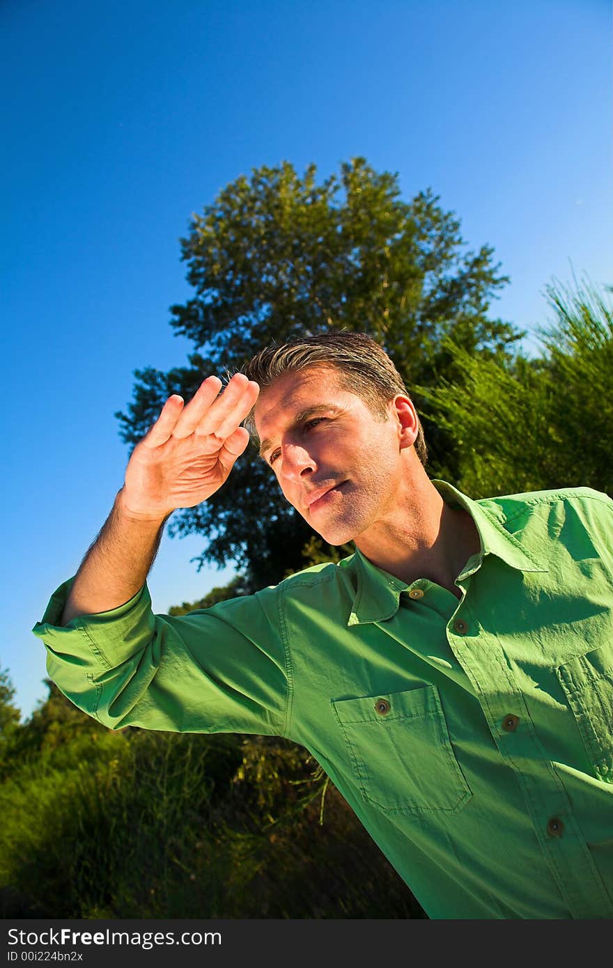 Man portrait outdoor on a field over blue sky