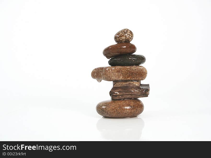 Six stones balancing on a white background