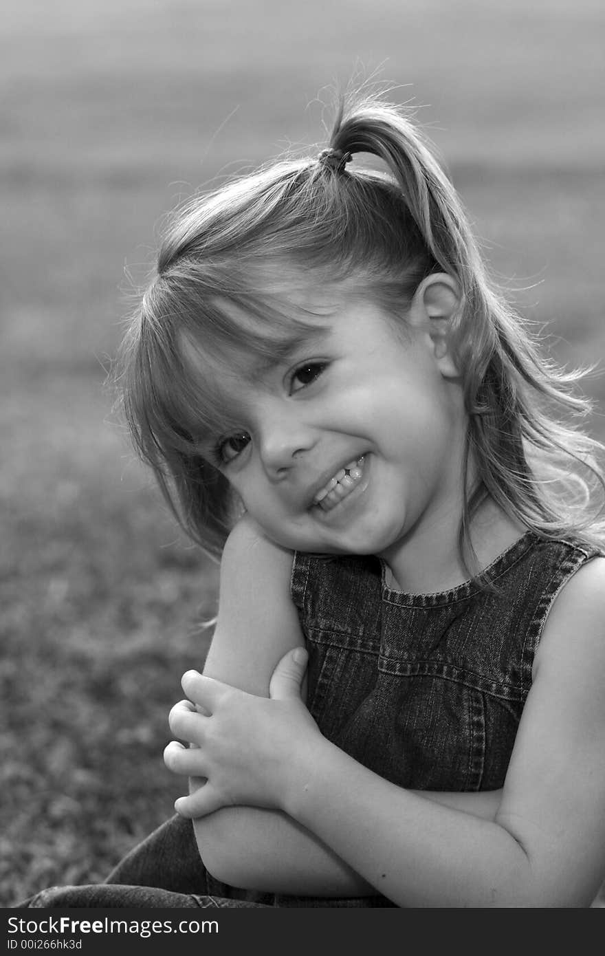 Young girl with big smile in grass. Young girl with big smile in grass