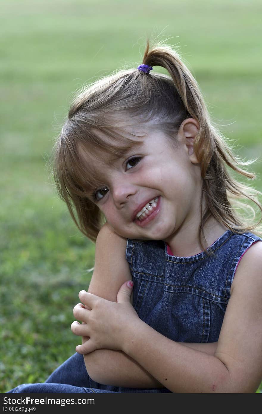 Young girl with big smile in grass. Young girl with big smile in grass