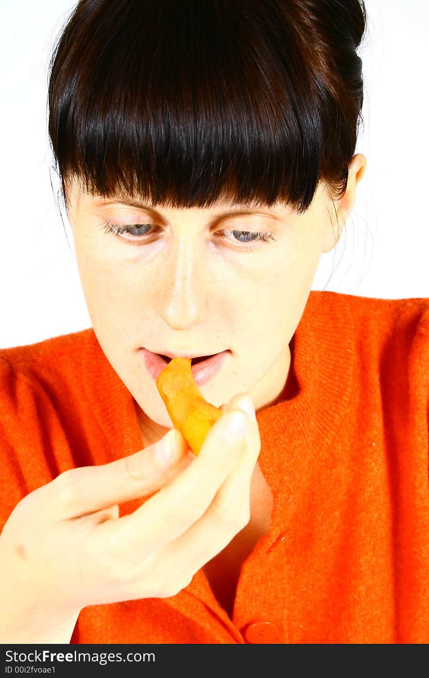 Young beautiful girl eating fresh orange. Young beautiful girl eating fresh orange