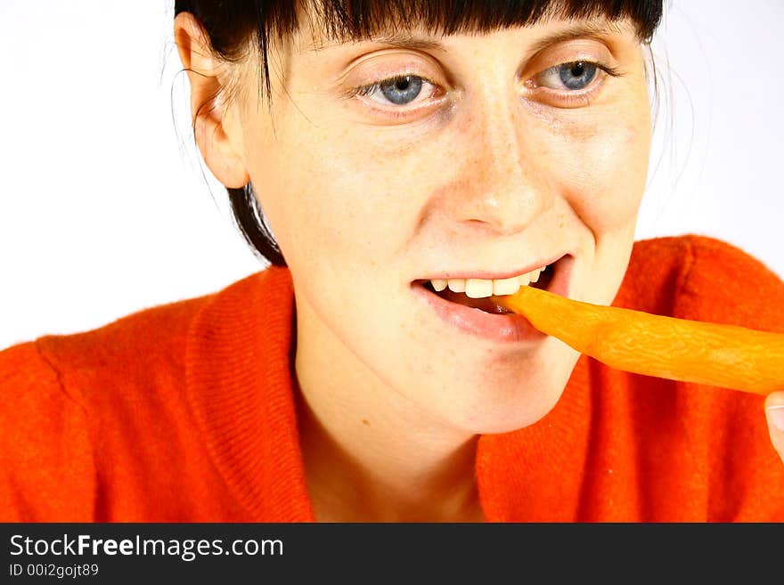 Young beautiful girl eating fresh orange. Young beautiful girl eating fresh orange