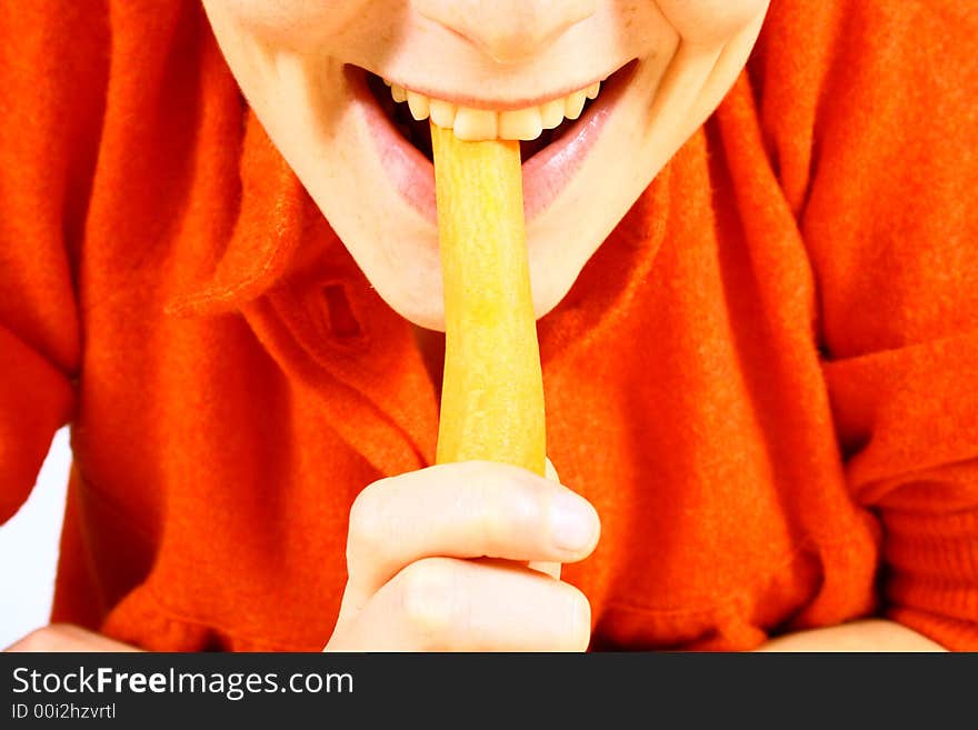 Young girl eating fresh carrot