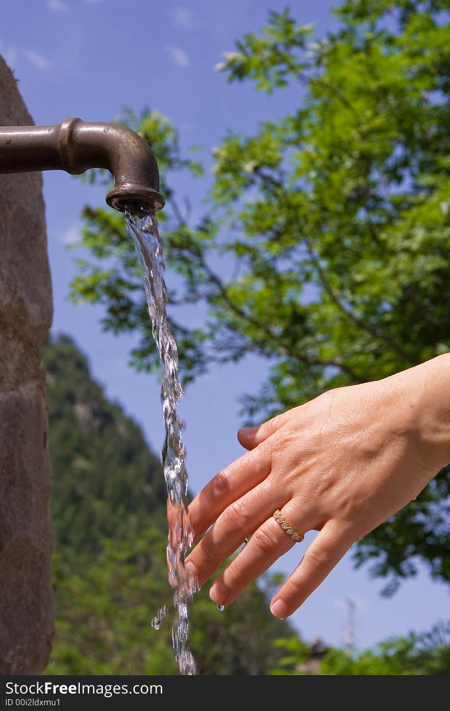 A hand under fresh water. A hand under fresh water