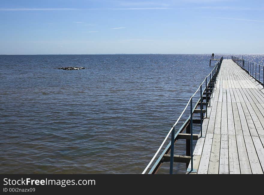 Sea pier on a background of the blue sky