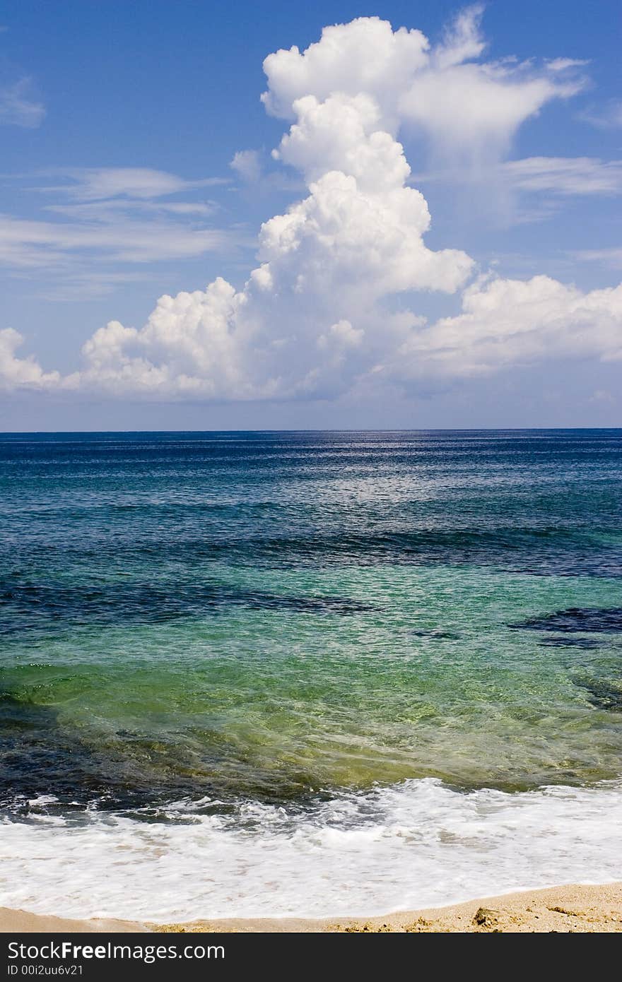 A view by the shore of clouds building over the sea. A view by the shore of clouds building over the sea