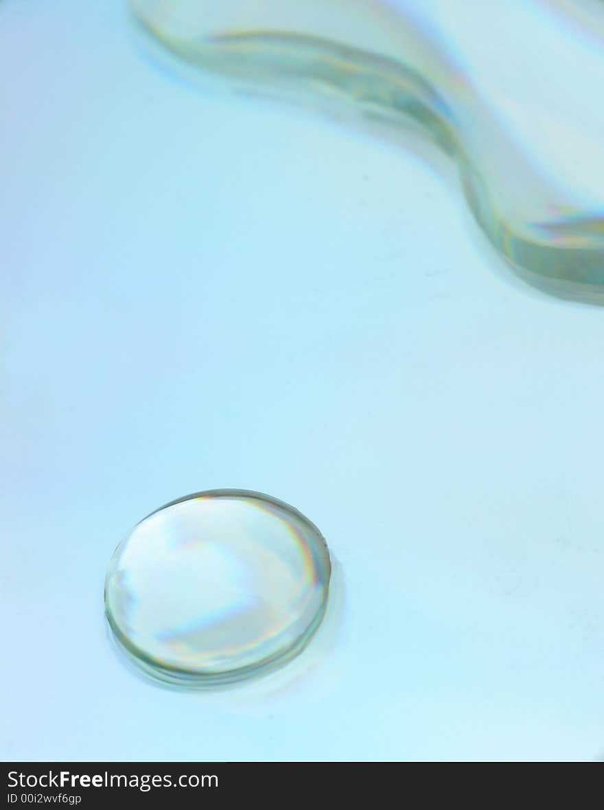 Water drops on a CD surface displaying all the colors of the rainbow. Water drops on a CD surface displaying all the colors of the rainbow