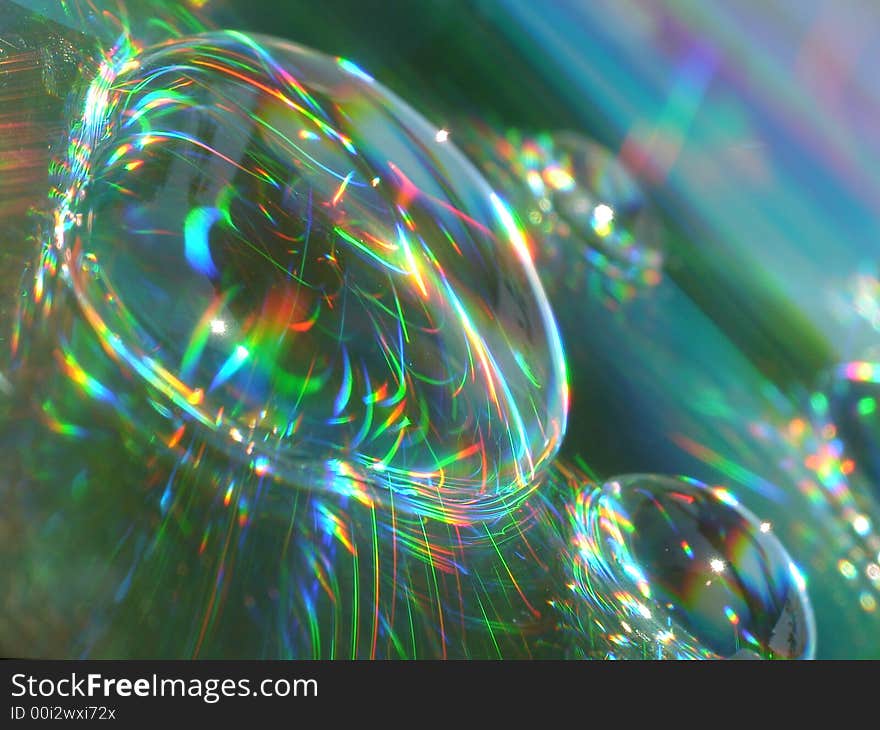 Water drops on a CD surface displaying all the colors of the rainbow. Water drops on a CD surface displaying all the colors of the rainbow