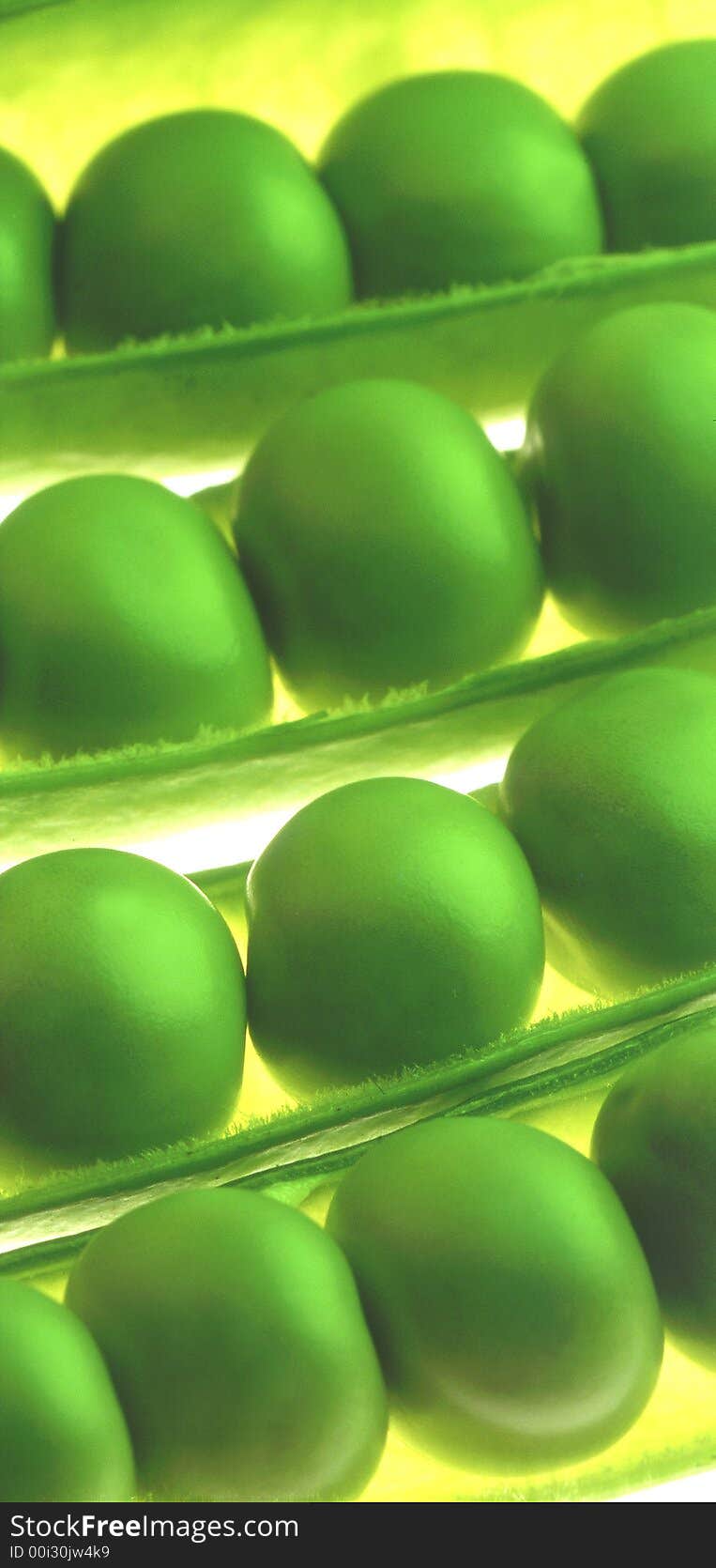 Green peas on a yellow background