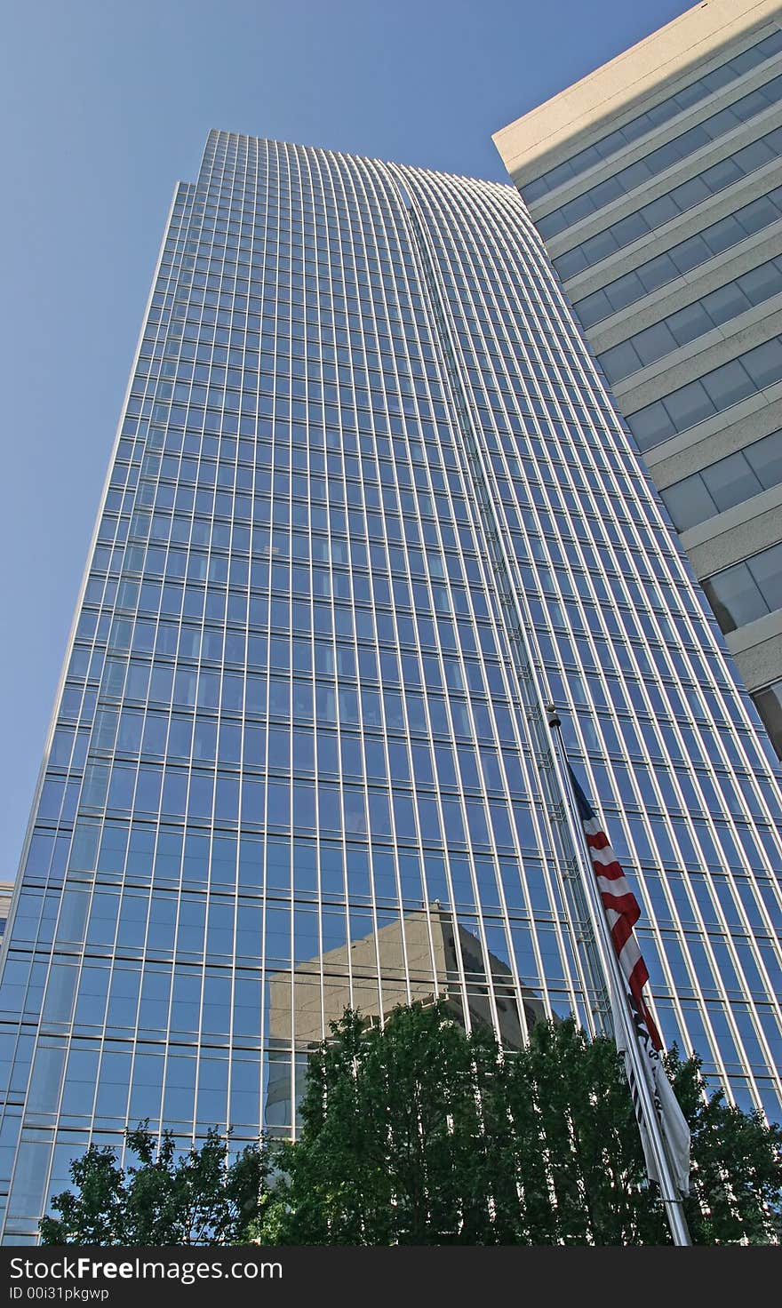 A modern glass skyscraper rising into the sky with buildings reflected. A modern glass skyscraper rising into the sky with buildings reflected