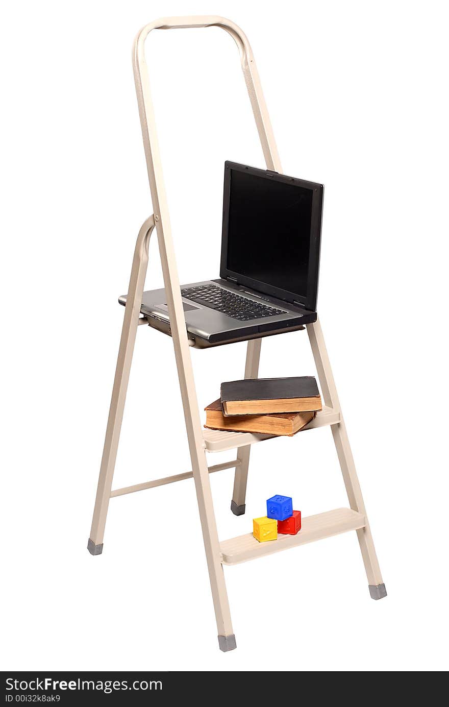 Computer, books and children's cubes lay on a ladder. Computer, books and children's cubes lay on a ladder