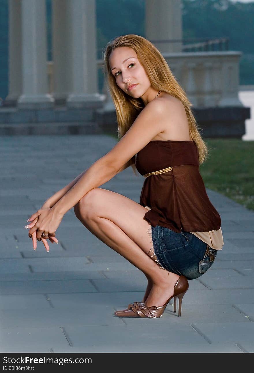 A beautiful young women posing by a gazebo. A beautiful young women posing by a gazebo