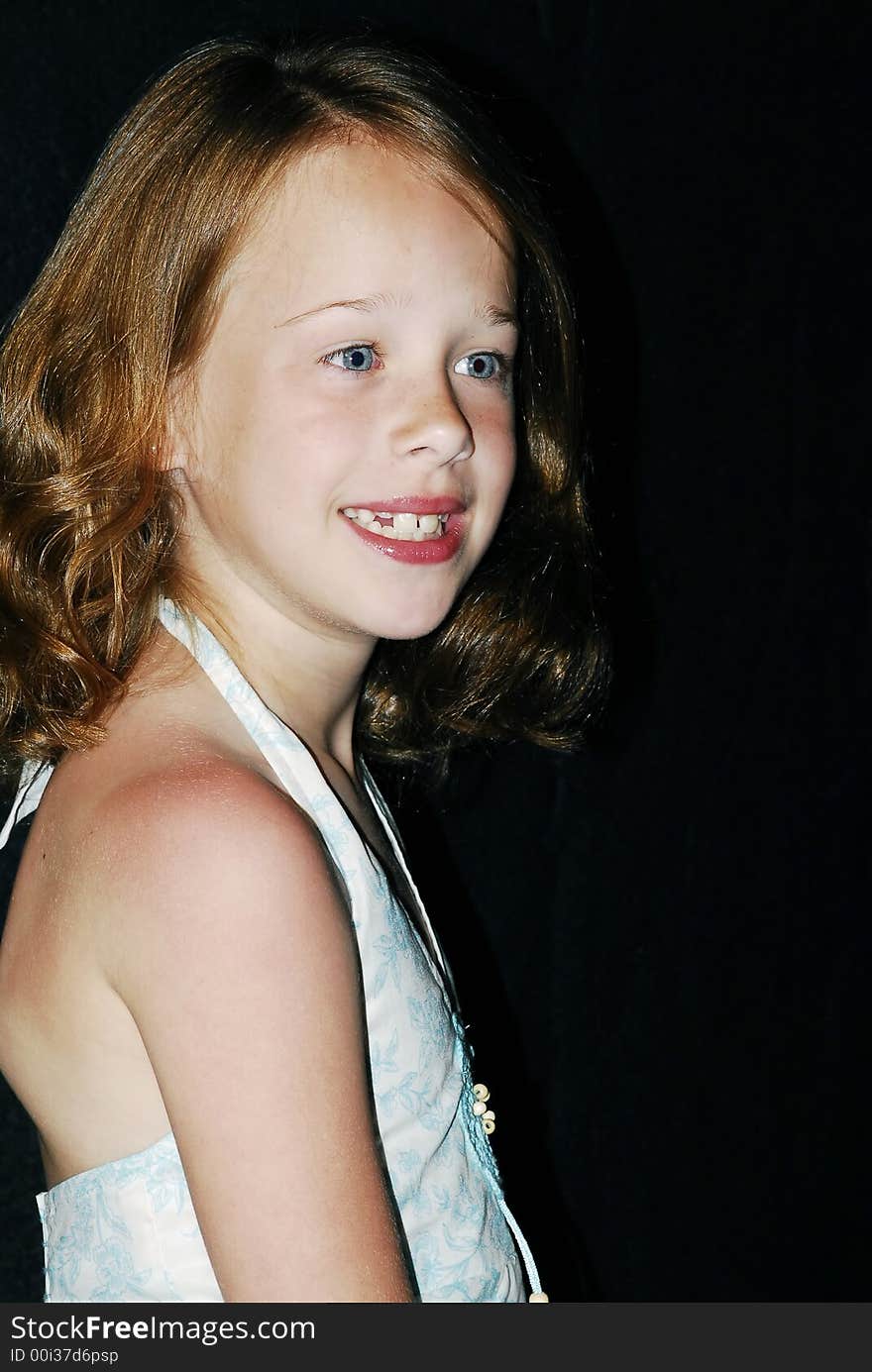 Pretty little young blue eyed girl with reddish brown hair and a big smile posing for a photo. Pretty little young blue eyed girl with reddish brown hair and a big smile posing for a photo.