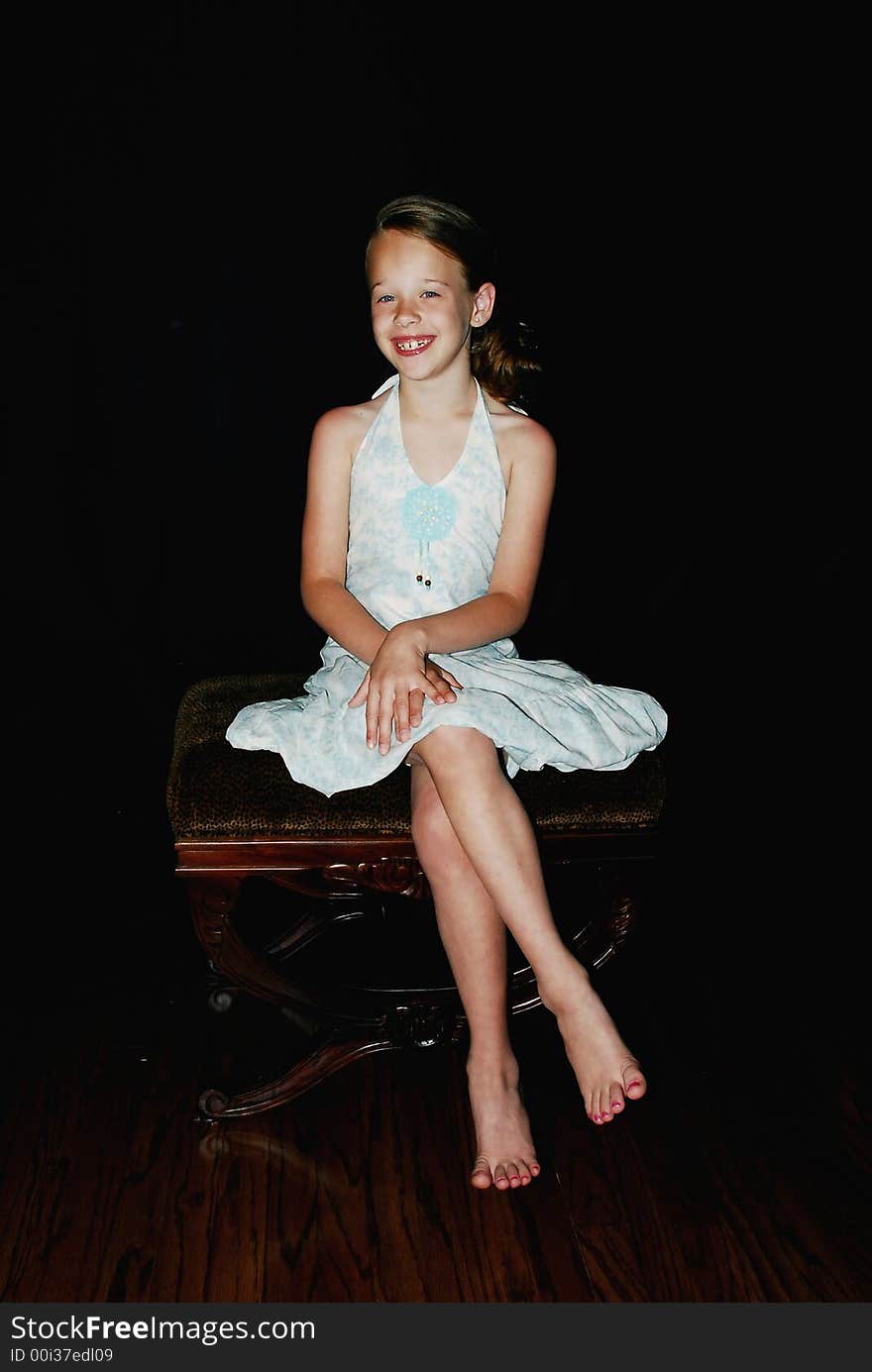 Little Girl with Big smile sitting on a bench posing. Little Girl with Big smile sitting on a bench posing.