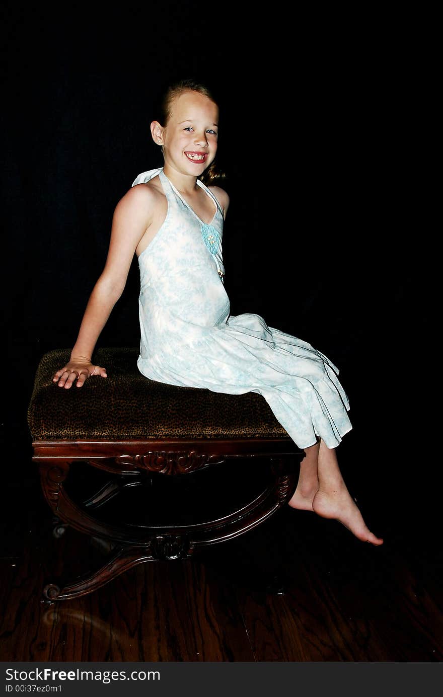 Little Girl with Big smile sitting on a bench posing. Little Girl with Big smile sitting on a bench posing.