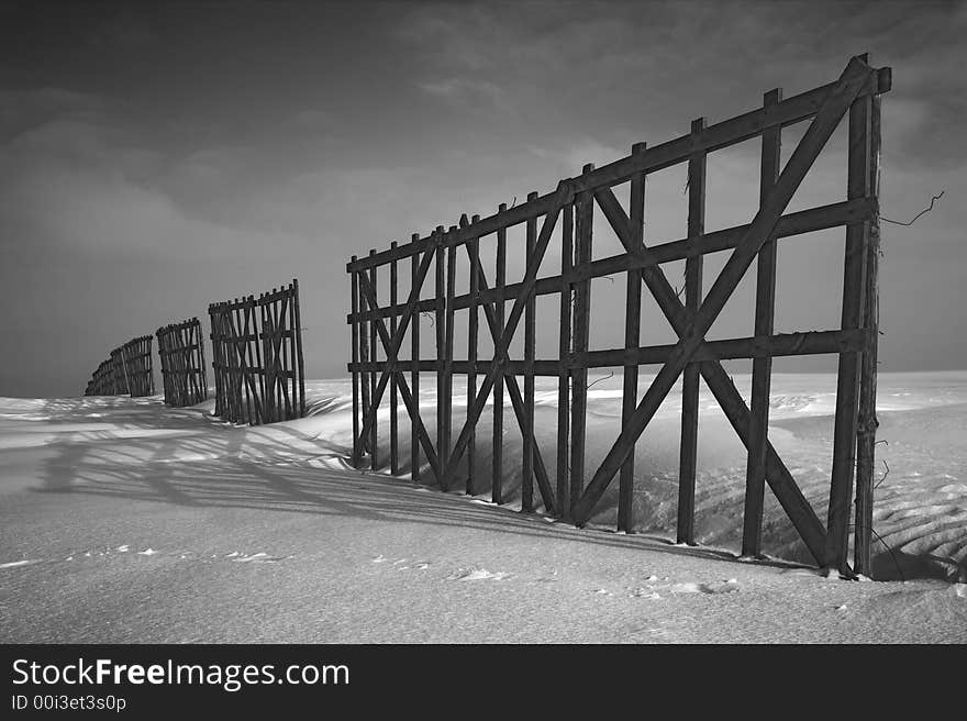 Perspective, winter and fence disappearing behind the horizon