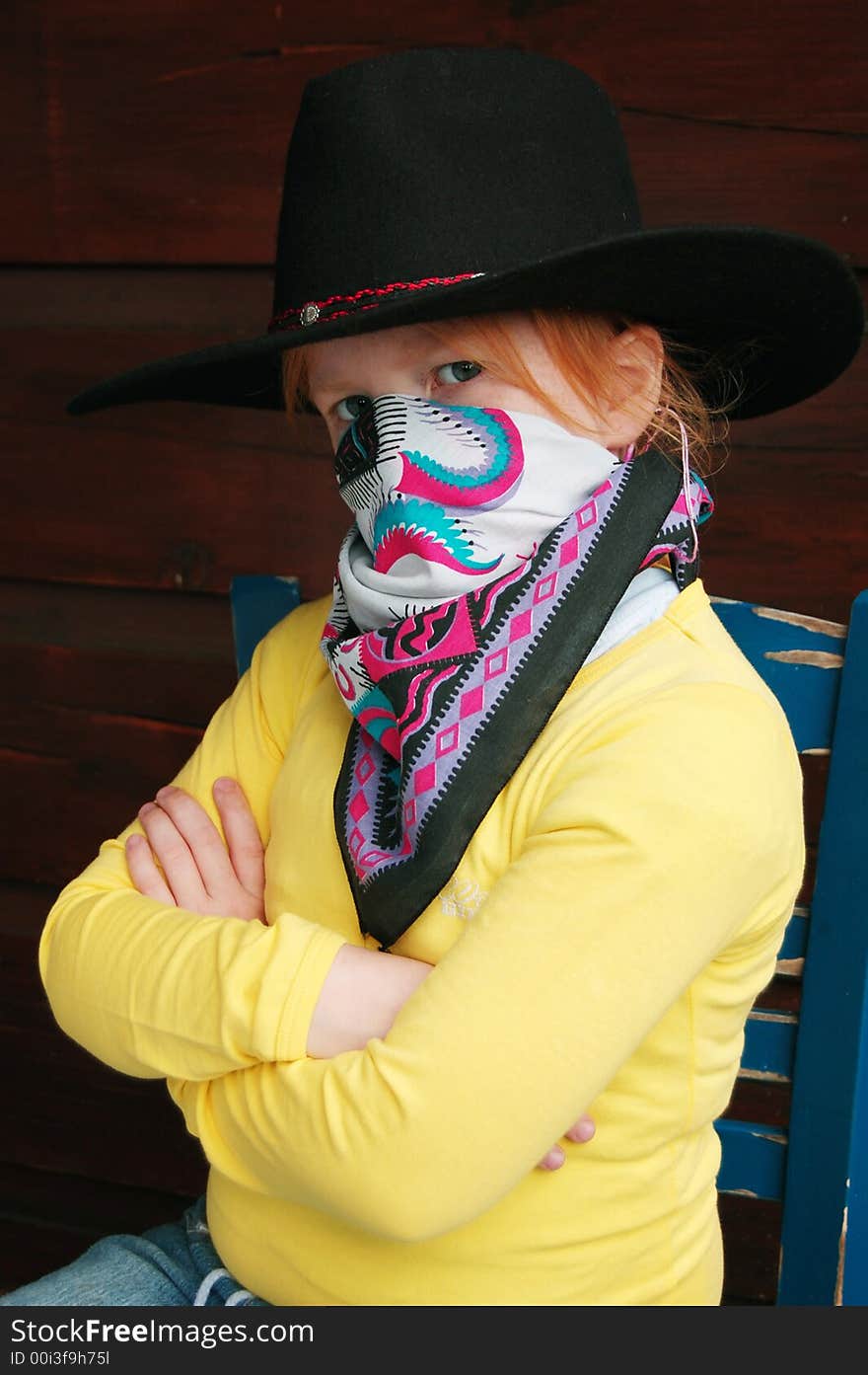 Little cowgirl sitting on a chair