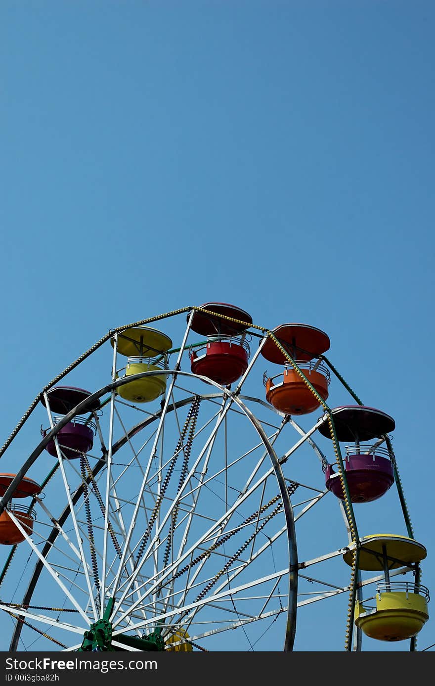 Ferris wheel with multicolored gondolas.