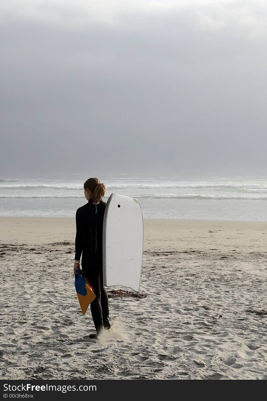 Body-boarder girl ready to go surfing. Body-boarder girl ready to go surfing