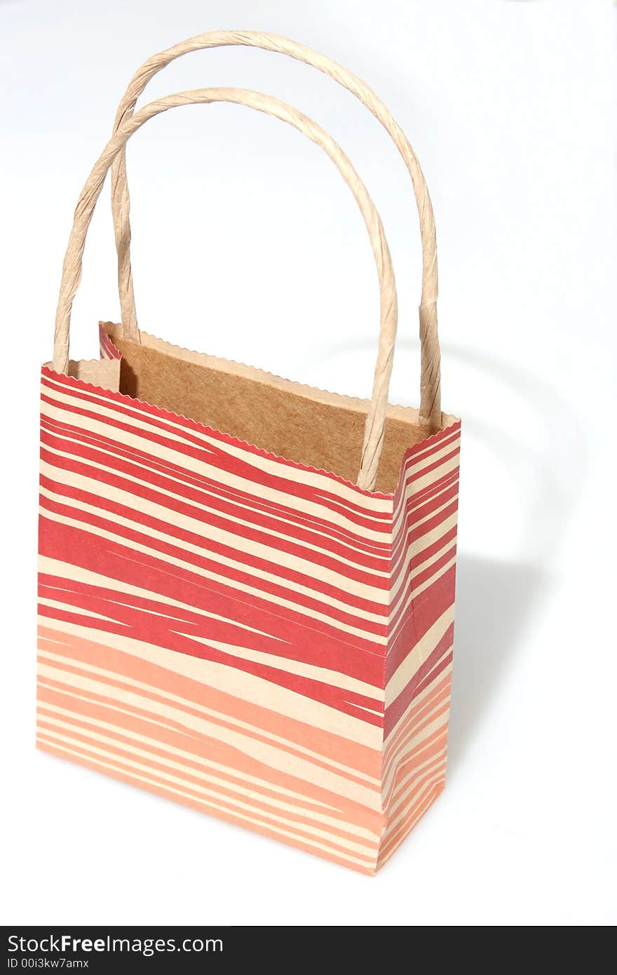 Empty red striped paperbag isolated on white