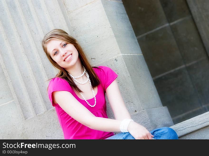 Portrait of a smiling teen sitting on the school steps. Portrait of a smiling teen sitting on the school steps.