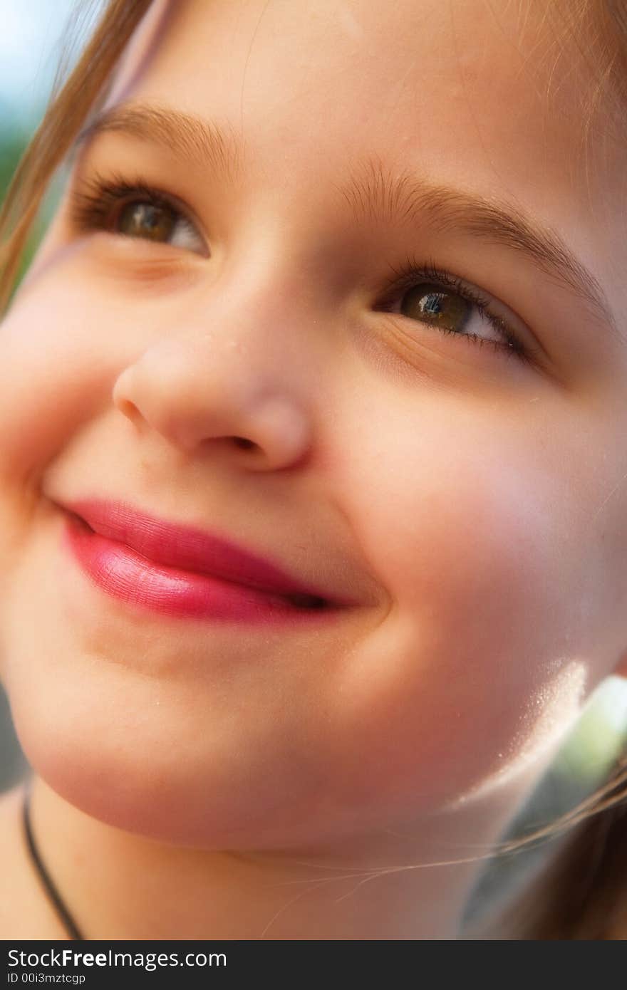 Full face portrait of a pretty little girl in natural light. Full face portrait of a pretty little girl in natural light.