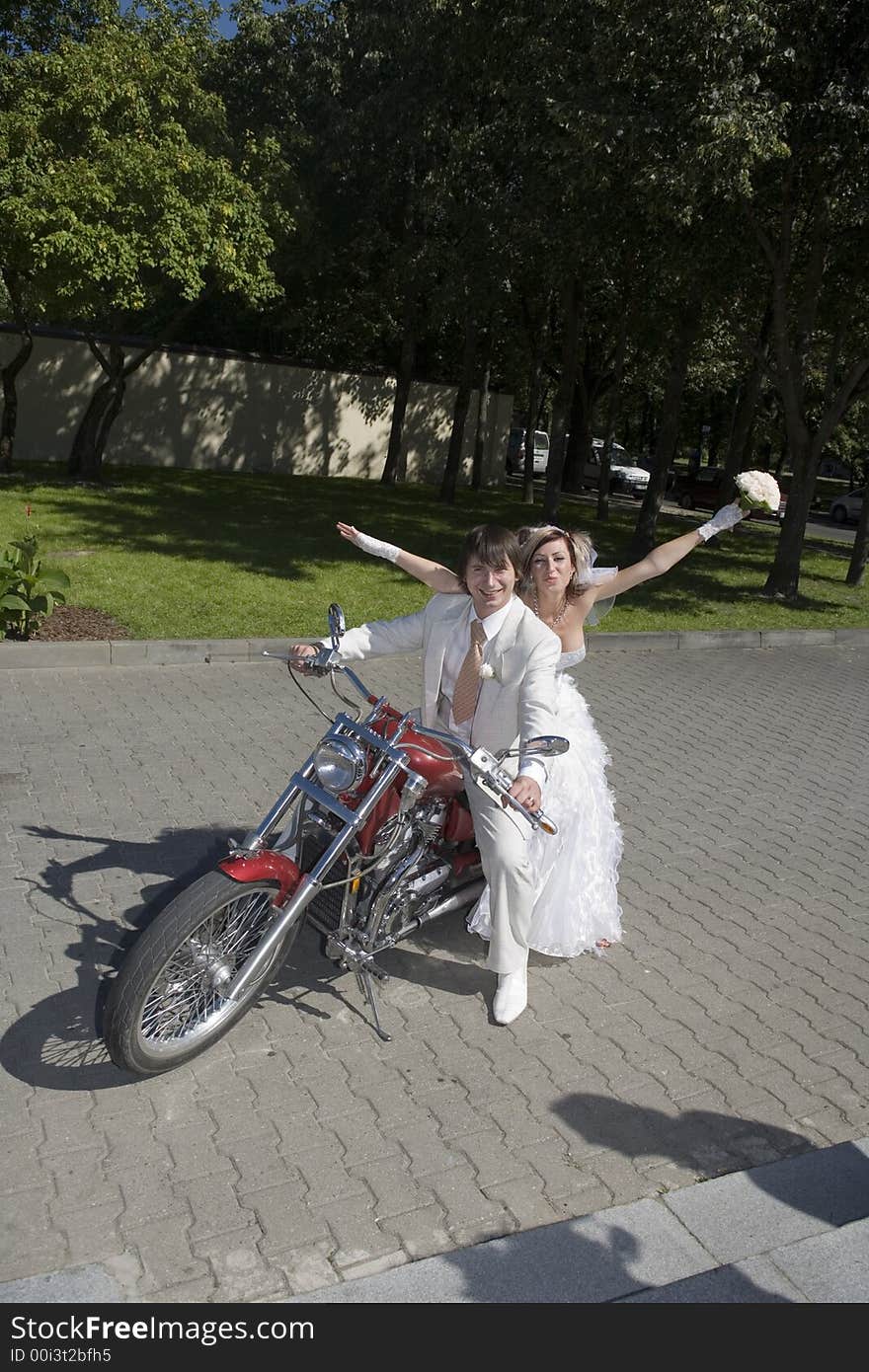 Bride and groom on a motorcycle