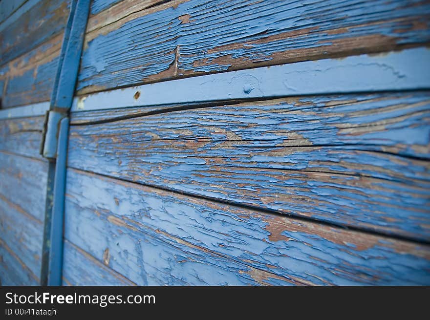 Grunge wooden background made of damaged planks with damaged color surface.