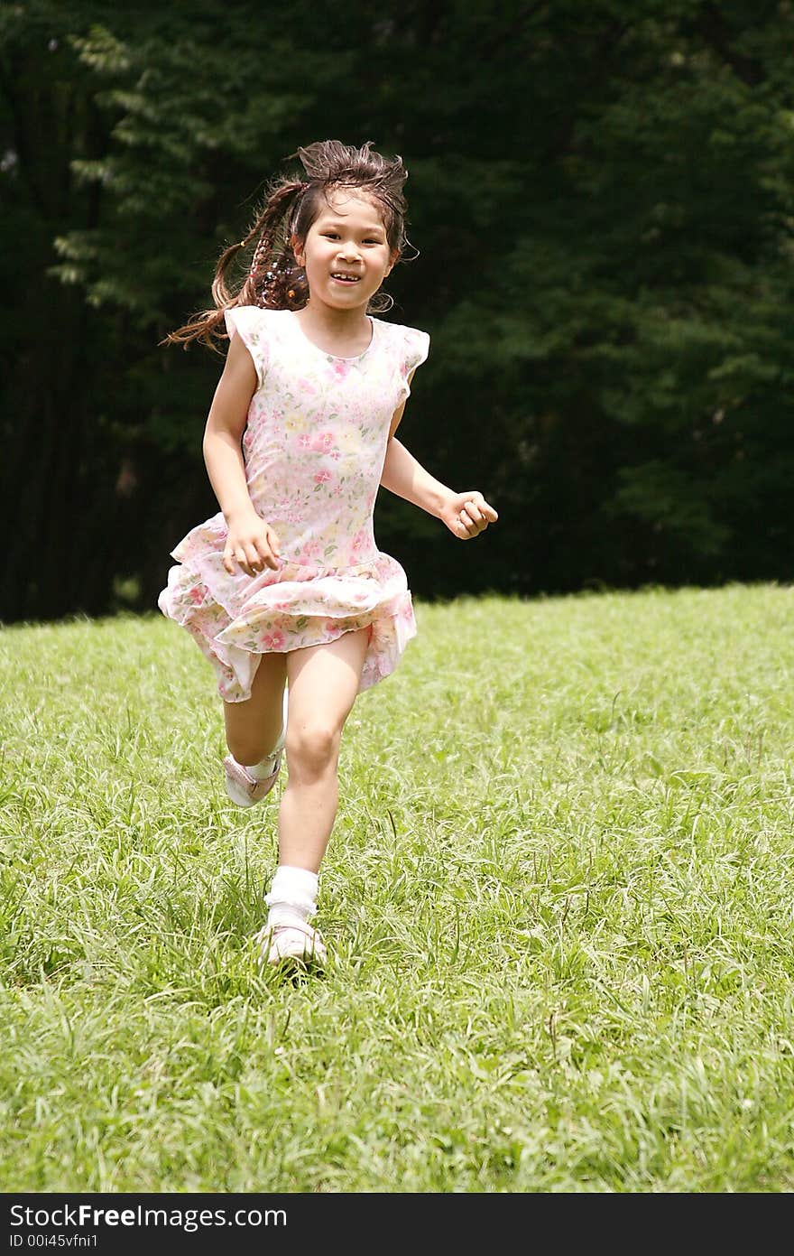 Girl run on green grass