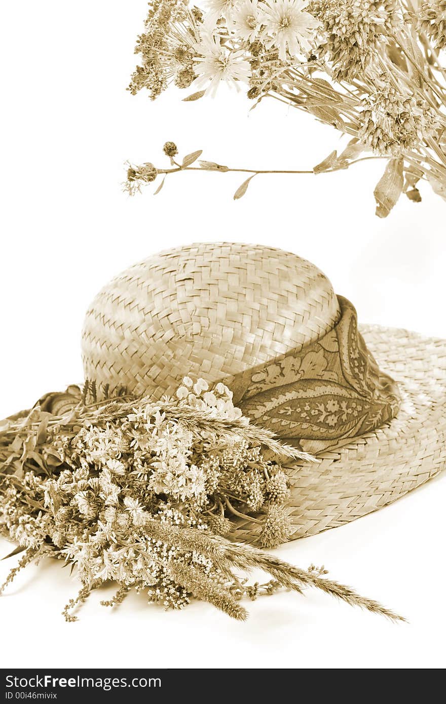 Straw hat and field flowers-retro beauty of a rural life