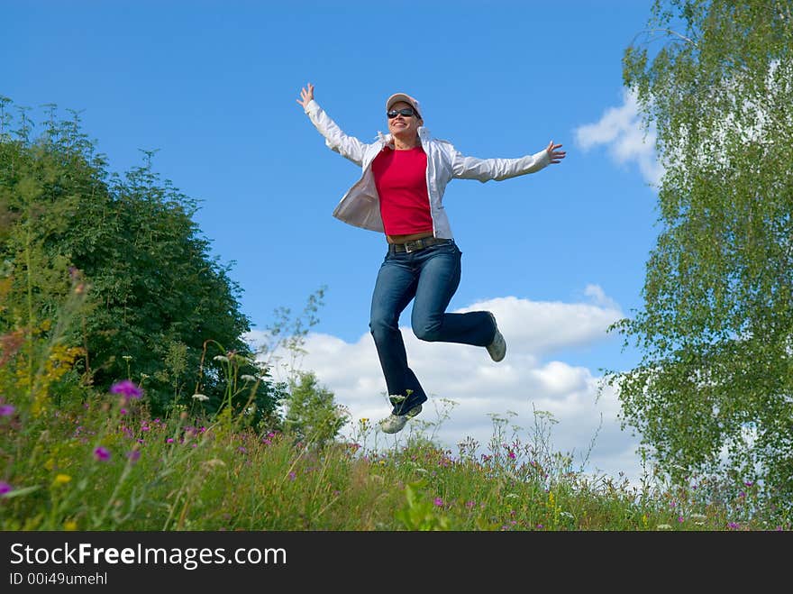 Beautiful lady jumping in summer landscape. Beautiful lady jumping in summer landscape