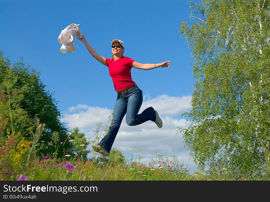 Beautiful lady jumping in summer landscape. Beautiful lady jumping in summer landscape